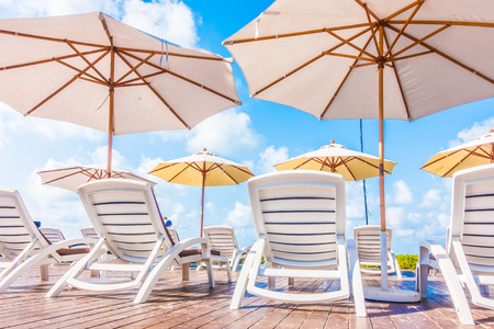 Beautiful luxury umbrella and chair around outdoor swimming pool in hotel resort - Holiday Vacation concept for backgroundの写真素材