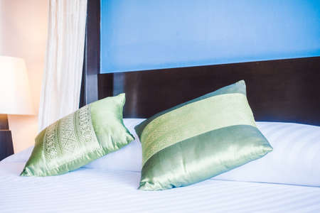 Beautiful luxury pillow on bed decoration in bedroom interior - Vintage light Filterの写真素材