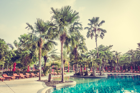 Beautiful luxury outdoor swimming pool with umbrella and chair in hotel pool resort - Vintage Filterのeditorial素材