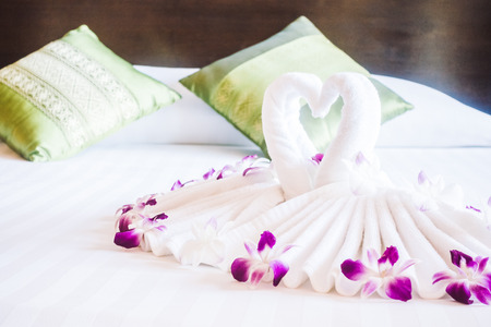 Romantic concept for background with Swan towel on bed decoration in bedroom interior - Vintage light Filterの写真素材