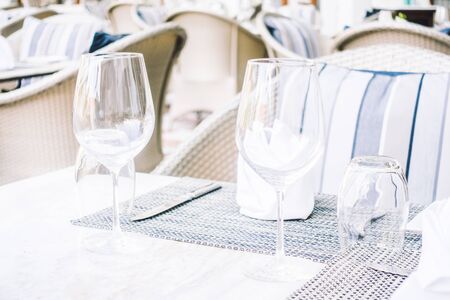 Selective focus point on table setting with wine glass , fork , knife , flower vase and other decoration in restaurant interior - Vintage Light Filterの写真素材