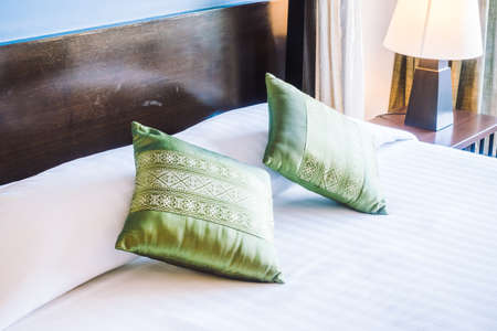 Beautiful luxury pillow on bed decoration in bedroom interior - Vintage light Filterの写真素材
