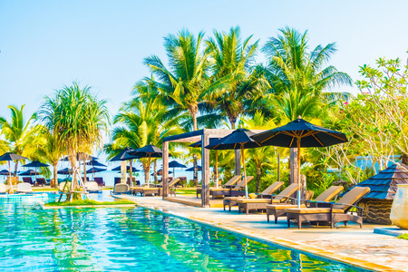 Umbrella and chair around beautiful luxury outdoor swimming pool in hotel resort - Boost up color Processingのeditorial素材
