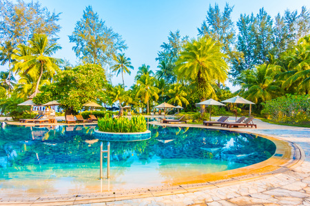 Umbrella and chair around beautiful luxury outdoor swimming pool in hotel resort - Boost up color Processingのeditorial素材
