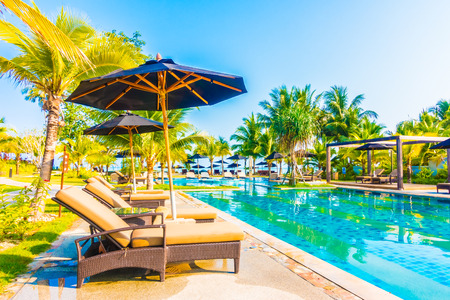 Umbrella and chair around beautiful luxury outdoor swimming pool in hotel resort - Boost up color Processingのeditorial素材