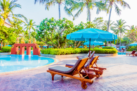 Beautiful luxury outdoor swimming pool with umbrella and chair in hotel pool resort - Vintage light Filterのeditorial素材