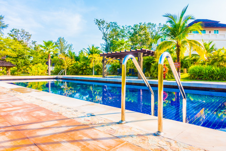 Beautiful luxury umbrella and chair around swimming pool in hotel resort - Boost up color Processingのeditorial素材
