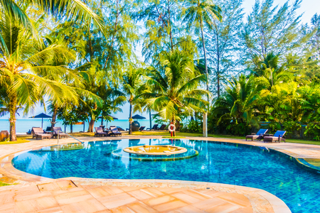Beautiful luxury umbrella and chair around swimming pool in hotel resort - Boost up color Processingのeditorial素材