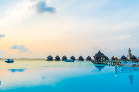 Beautiful luxury outdoor swimming pool with umbrella and chair in hotel resort at maldives - Boost up color and Filter effect Processingのeditorial素材