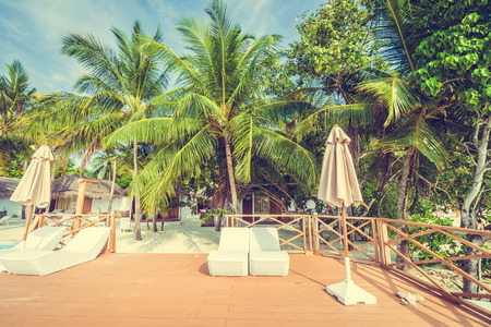 Beautiful luxury outdoor swimming pool with umbrella and chair in hotel resort at maldives - Boost up color and Filter effect Processingのeditorial素材