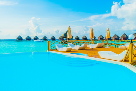 Beautiful luxury outdoor swimming pool with umbrella and chair in hotel resort at maldives - Boost up color and Filter effect Processingのeditorial素材