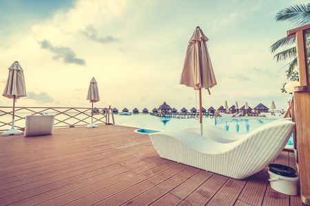 Beautiful luxury outdoor swimming pool with umbrella and chair in hotel resort at maldives - Boost up color and Filter effect Processingのeditorial素材