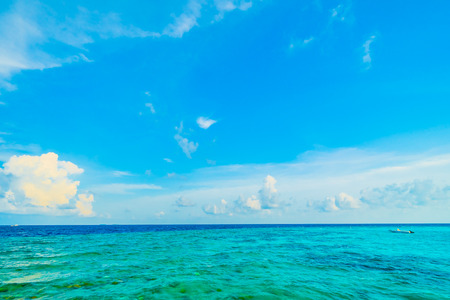 Beautiful tropical Maldives resort hotel and island with beach and sea on sky for holiday vacation background concept -Boost up color Processingの写真素材