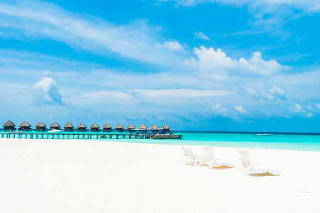 Umbrella and chair on the beautiful tropical beach and sea around hotel resort in maldives island - Boost up color Processingのeditorial素材