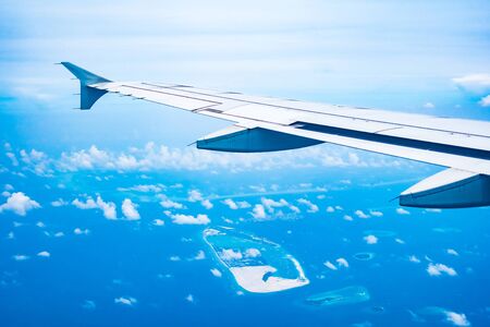 Aerial view of Beautiful tropical beach and sea in maldives island on blue sky background