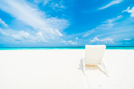 Umbrella and chair on the beautiful tropical beach and sea around hotel resort in maldives island - Boost up color Processingの写真素材