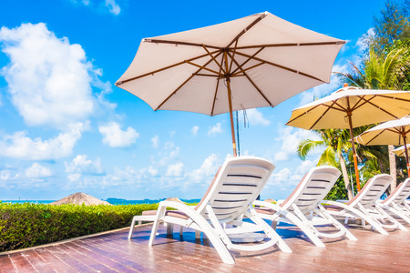 Beautiful luxury umbrella and chair around outdoor swimming pool in hotel resort - Holiday Vacation concept for backgroundの写真素材