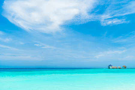 Beautiful tropical Maldives resort hotel and island with beach and sea on sky for holiday vacation background concept - Boost up color Processingの写真素材