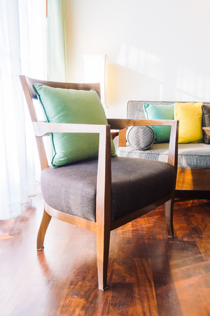 Beautiful luxury pillow on sofa chair decoration with table light lamp in living area room interior - Vintage light Filterの写真素材