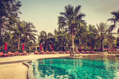 Beautiful luxury outdoor swimming pool with umbrella and chair in hotel pool resort - Vintage Filterのeditorial素材
