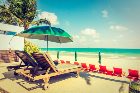 Vintage Filter - Umbrella and chair on beautiful tropical beach and sea - Boost up color Processing - Holiday vacation concept backgroundのeditorial素材