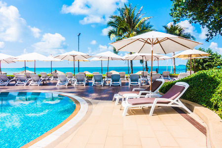 Beautiful luxury umbrella and chair around outdoor swimming pool in hotel resort - Holiday Vacation concept for backgroundのeditorial素材