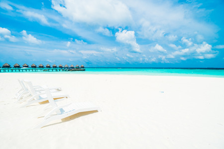 Umbrella and chair on the beautiful tropical beach and sea around hotel resort in maldives island - Boost up color Processingのeditorial素材
