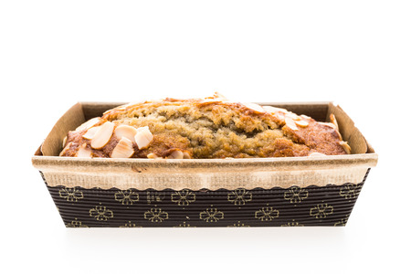 Banana cake with almond on top isolated on white background