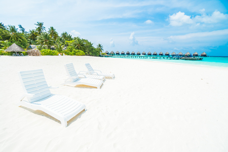 Umbrella and chair on the beautiful tropical beach and sea around hotel resort in maldives island - Boost up color Processingのeditorial素材
