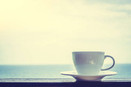 White coffee cup with outdoor view - Vintage Filterの写真素材