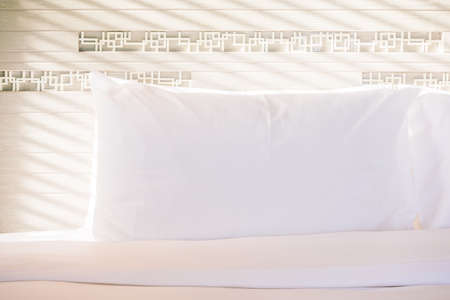 Beautiful white pillow on bed decoration in bedroom interior - Vintage light Filterの写真素材