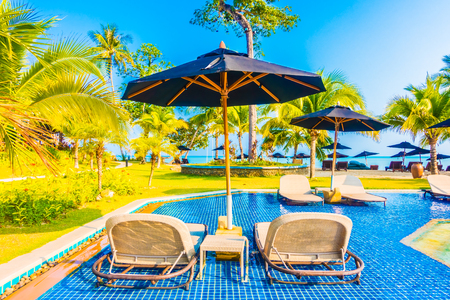 Umbrella and chair around beautiful luxury outdoor swimming pool in hotel resort - Boost up color Processingのeditorial素材
