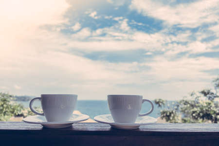 White coffee cup with outdoor view - Vintage Filterの写真素材