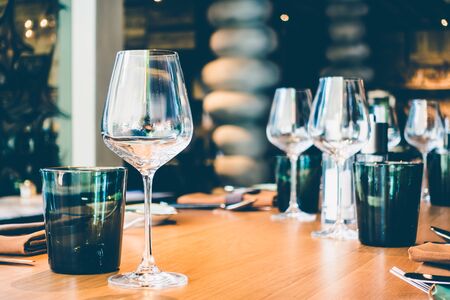 Selective focus point on wine glass with table setting for dinner in restaurant interior - Vintage Filterの写真素材