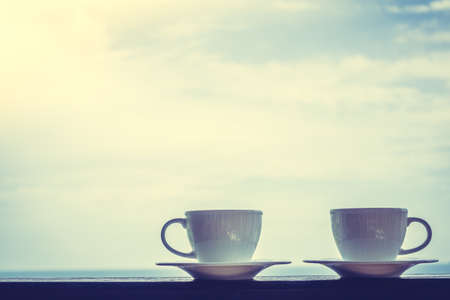 White coffee cup with outdoor view - Vintage Filterの写真素材