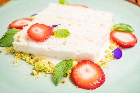 Sweet dessert with Coconut cake with strawberry on topの写真素材