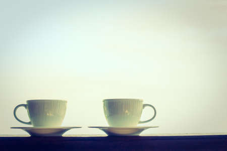 White coffee cup with outdoor view - Vintage Filterの写真素材