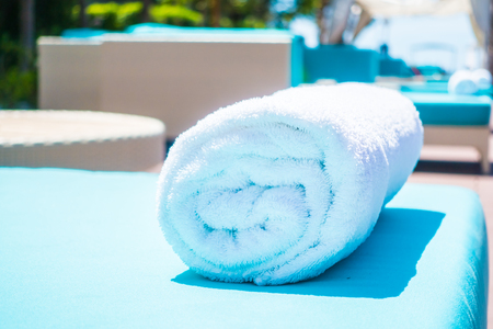 Pool towel on chair decoration around swimming pool in hotel resortの写真素材
