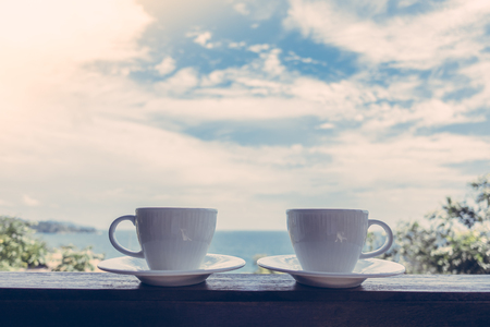 White coffee cup with outdoor view - Vintage Filterの写真素材