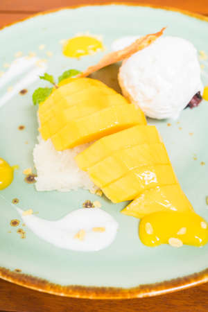 Sticky rice with sweet mango and ice creamの写真素材