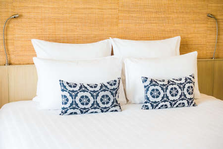 Beautiful white pillow on bed decoration in bedroom interiorの写真素材