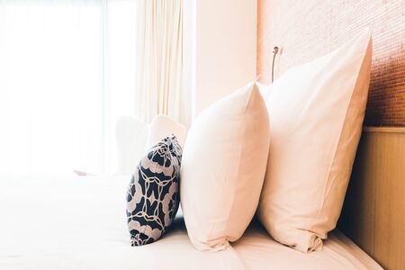 Beautiful white pillow on bed decoration in bedroom interior - Filter effect