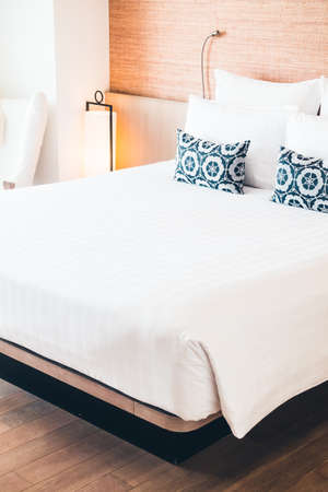 Beautiful white pillow on bed decoration in bedroom interior - Filter effect