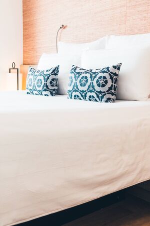 Beautiful white pillow on bed decoration in bedroom interior - Filter effect