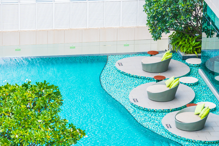 Umbrella and chair around beautiful luxury outdoor swimming pool in hotel resort - Filter effect and sunflare Filterのeditorial素材