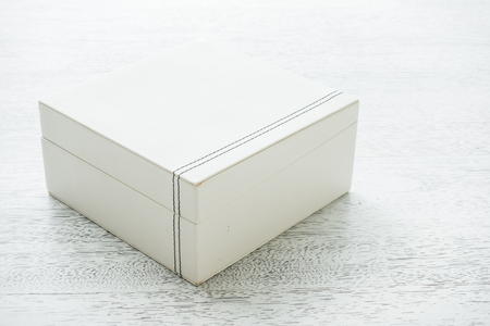 White leather box on wooden backgroundの写真素材
