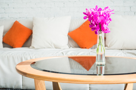Vase flower with pillow on sofa decoration in living room interiorの写真素材