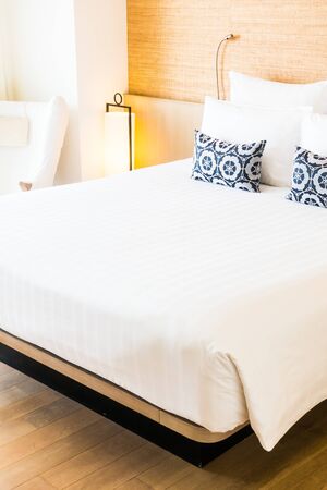 Beautiful white pillow on bed decoration in bedroom interiorの写真素材