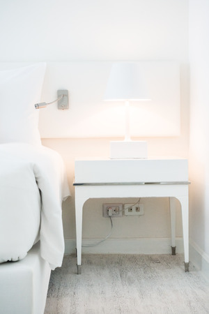 White pillow on bed with table light lamp decoration in bedroom interiorの写真素材