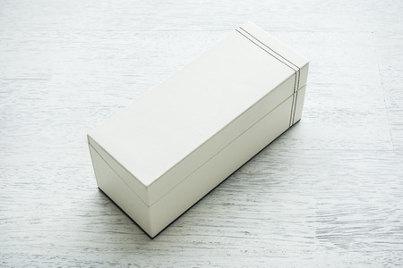White leather box on wooden backgroundの写真素材